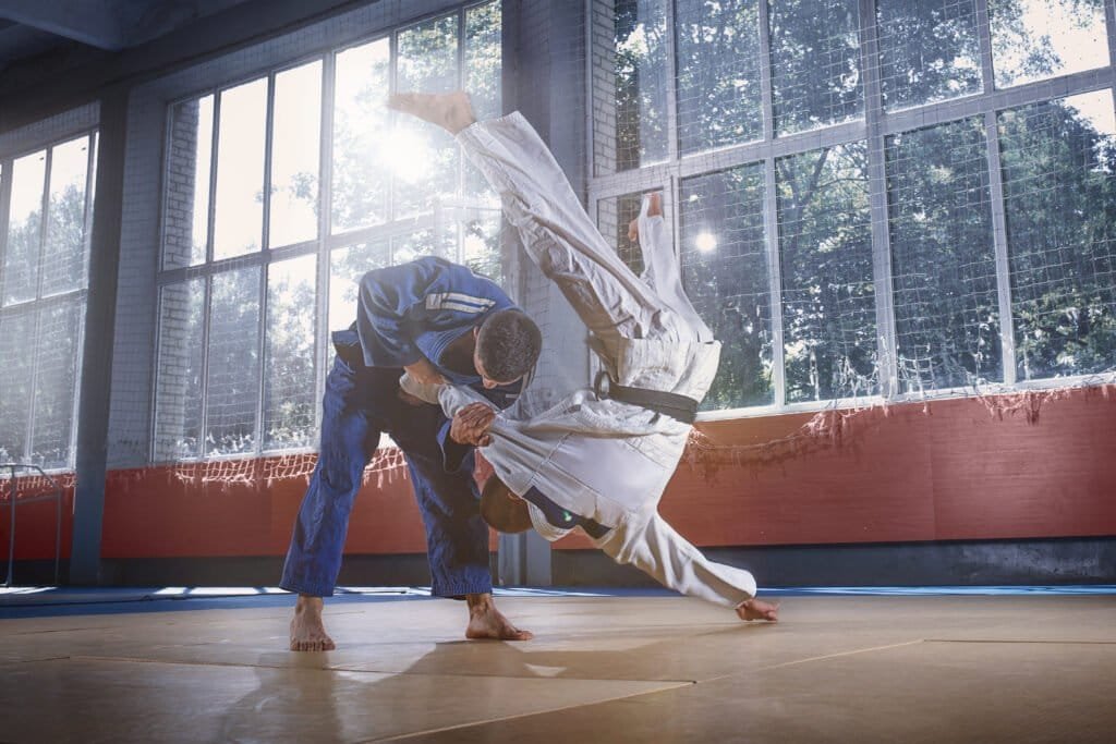 Two judo fighters showing technical skill while practicing martial arts in a fight club