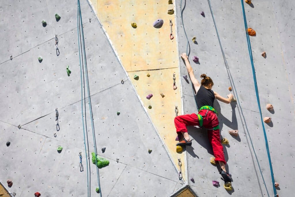 Girl climbing up the wall